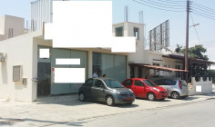 A detached house with two shops on a corner plot for sale 