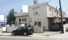A detached house with two shops on a corner plot for sale 