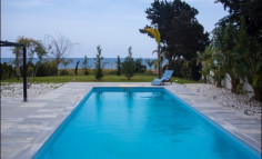For sale two beachfront plots of land with houses in Larnaca 